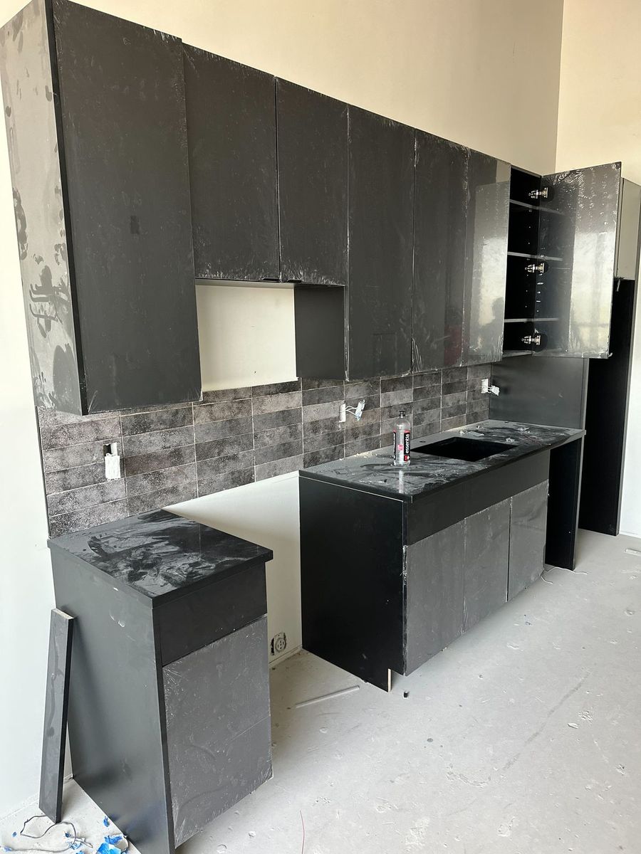 Matte black slab cabinet interior and shelves on a multifamily kitchen package