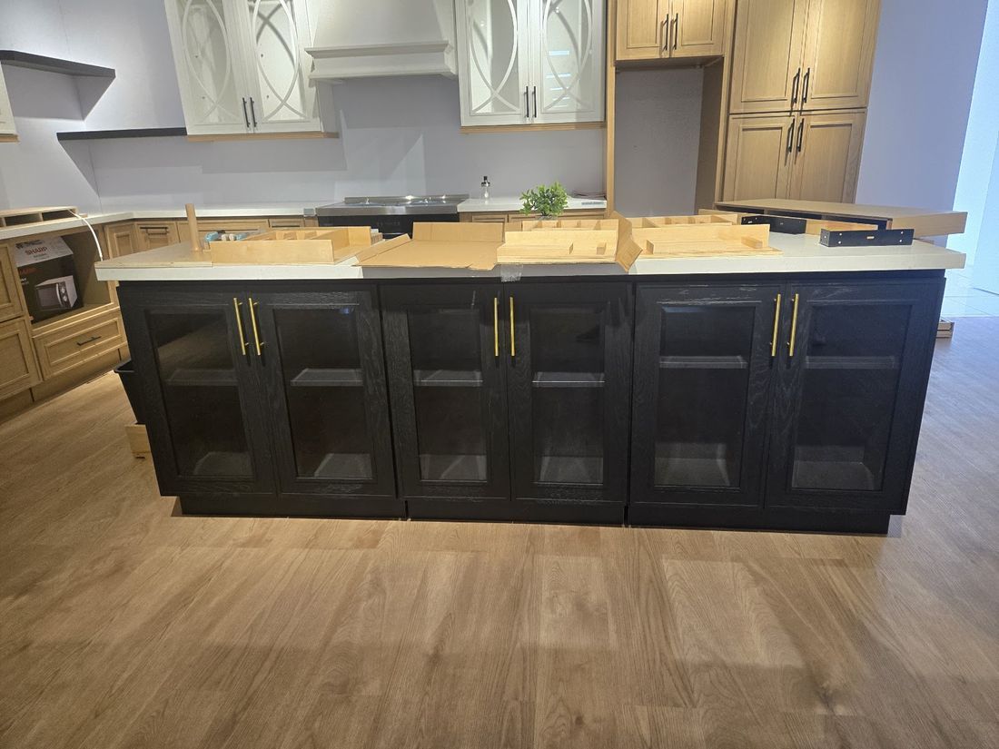 Dark glass-door island cabinet finish option for multifamily and leasing kitchens