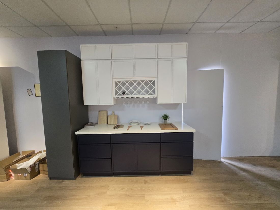 Navy and white contractor-grade kitchen cabinets with white countertop for apartment units