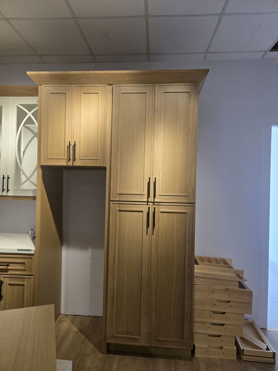 Light oak pantry and refrigerator surround cabinets for multifamily kitchen packages