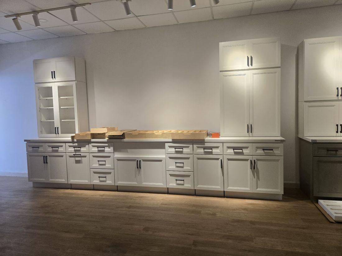 White shaker multifamily kitchen cabinets with black hardware and quartz-ready counters